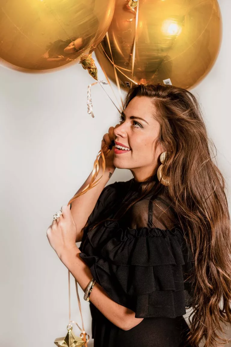 Megan posing with gold balloons