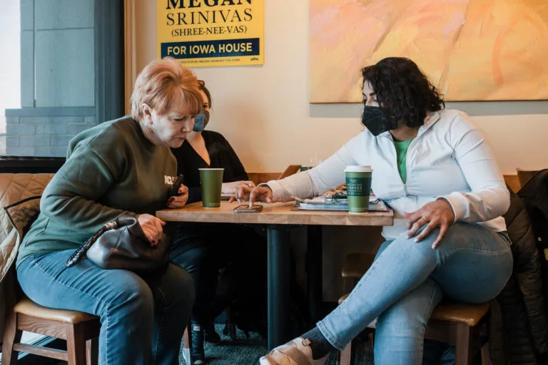 Dr. Megan Srinivas helps volunteers set up their canvassing app