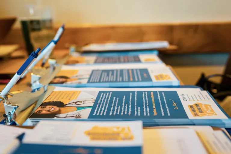 A row of clipboards with campaign literature pinned to them